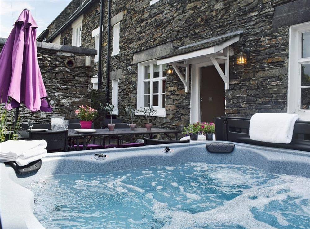 Inviting hot tub in private rear courtyard at White Moss in Windermere, Cumbria