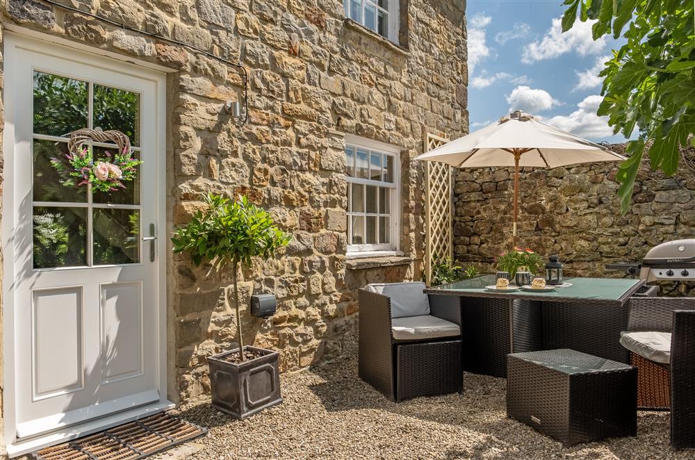 Secluded outside dining area at White Rose Cottage, Constable Burton, Leyburn