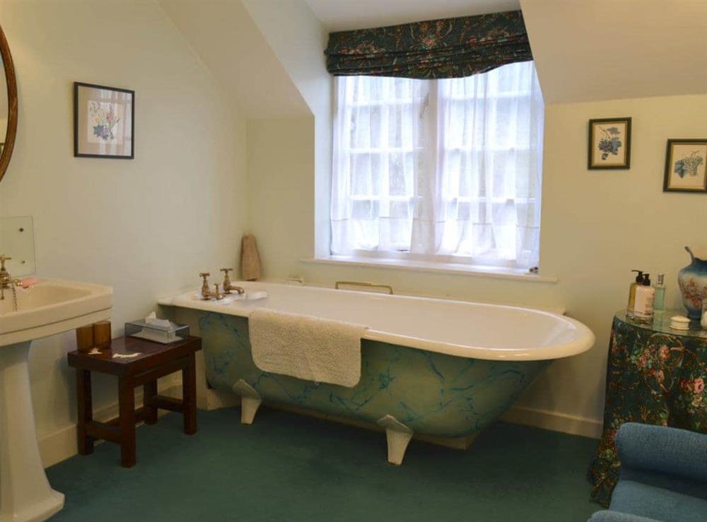 Bathroom with Victorian roll-top bath and toilet at White Rose Cottage in Fylingthorpe, Nr Whitby, N. Yorkshire., North Yorkshire