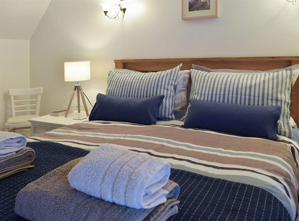Cosy double bedroom with kingsize bed at White Stones Cottage in Caister-on-Sea, near Great Yarmouth, Norfolk