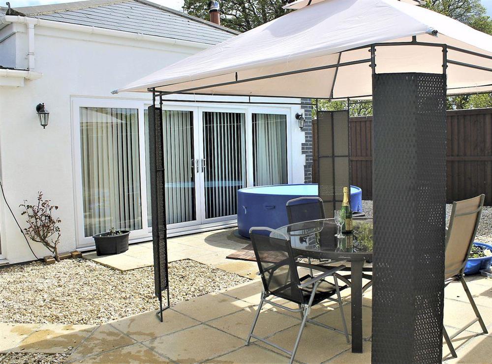 Paved patio area with hot tub and outdoor dining furniture at White View Lodge in Crook, near Bishop Auckland, County Durham, England