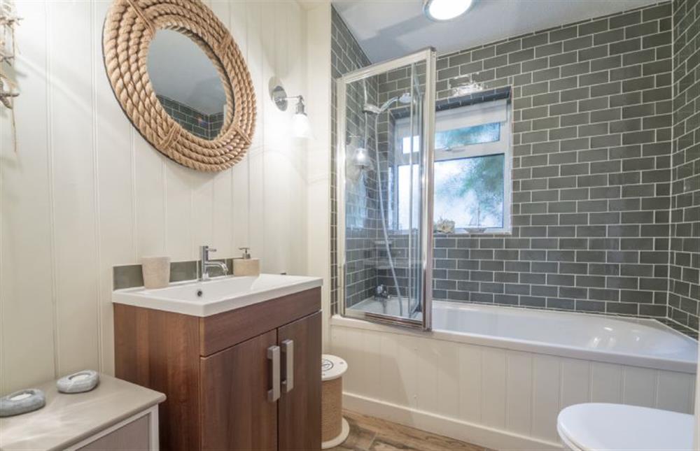Ground floor: Bathroom with bath and shower over at Whitehaven, Brancaster near Kings Lynn