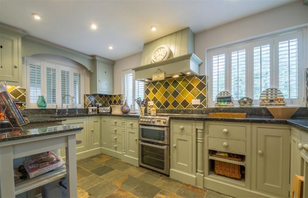 Ground floor: Kitchen with hand painted cupboards and granite worktops at Whitehaven, Brancaster near Kings Lynn