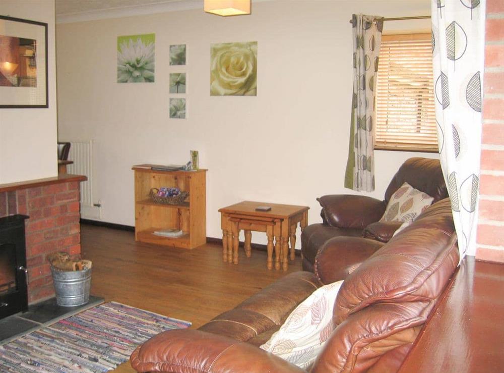 Welcoming living room with cosy wood burner at The Granary, 