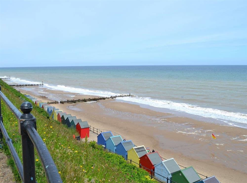 The coastline with beach-huts at Wallages Cottage, 