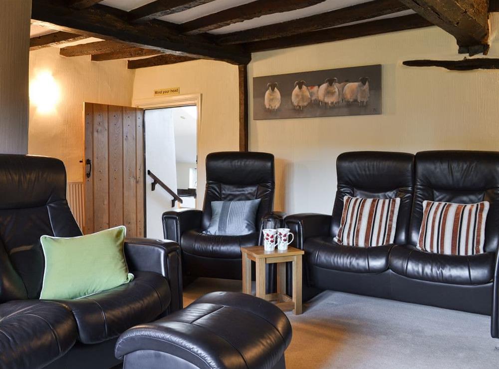Cosy living room with wood burner at The Farmhouse, 