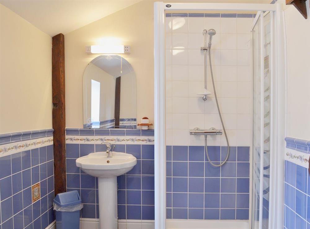 The en suite shower room  is half-tiled and features a walk-in full height shower at Ashleys, 