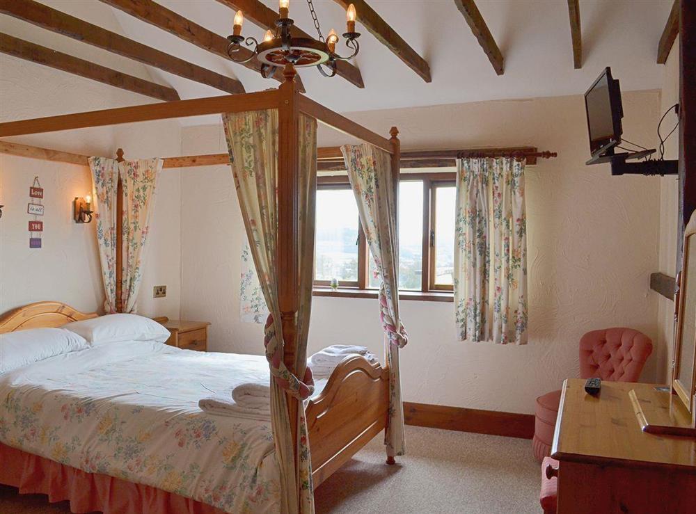 The romantic four poster bedroom has added charm thanks to exposed woodwork and sloping ceilings at Ashleys, 