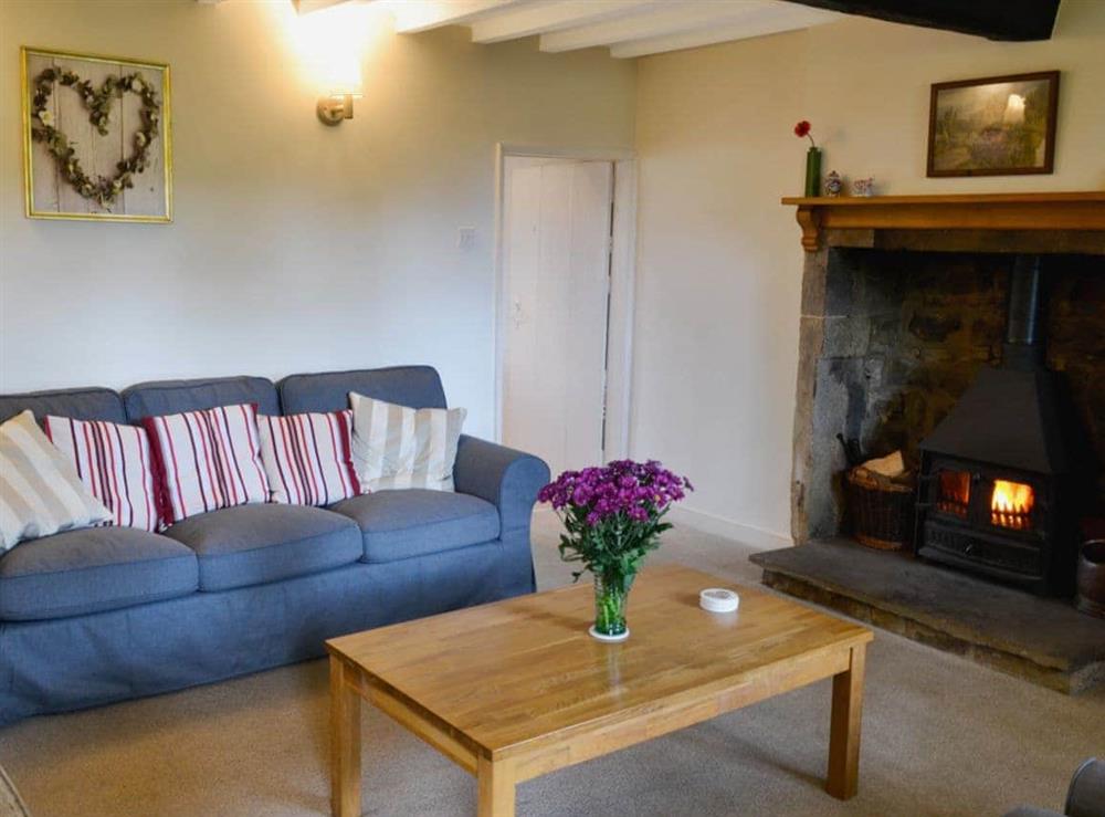 Delightful living room with beamed ceiling and woodburner at Wickwoods in Wath, near Pateley Bridge, North Yorkshire