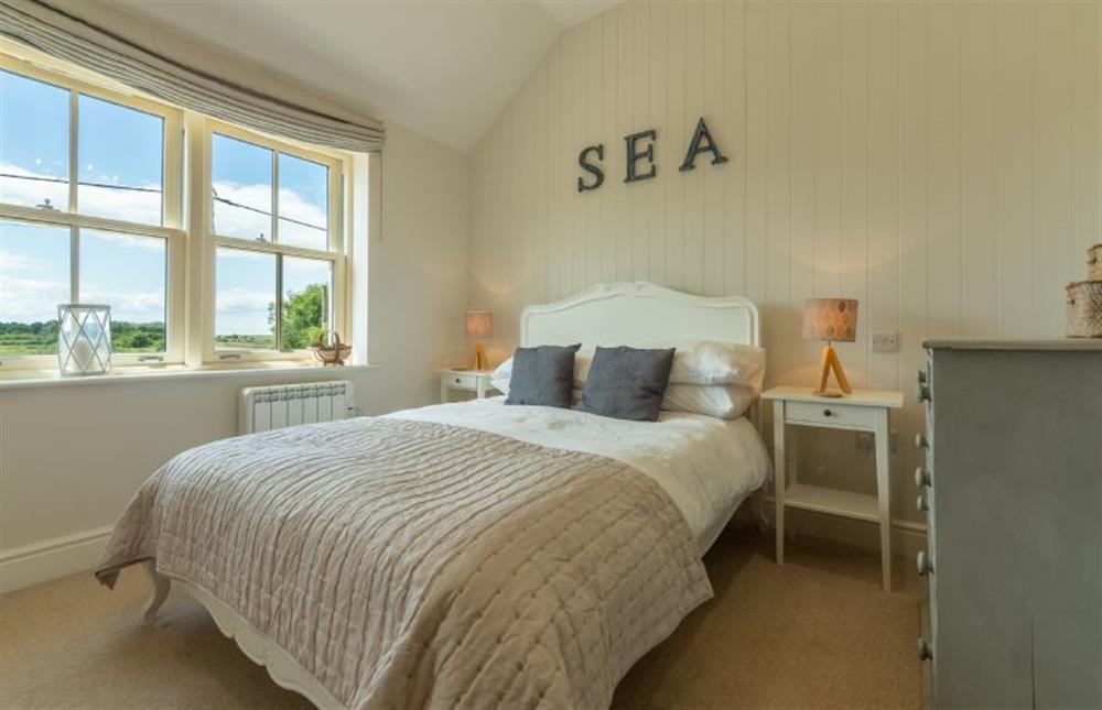 First floor: Master bedroom has lovely twin aspect views at Wigeon Cottage, Thornham near Hunstanton
