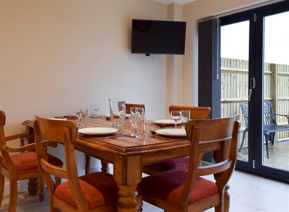 Dining area and bi-fold doors leading to garden at Cornfield View, 
