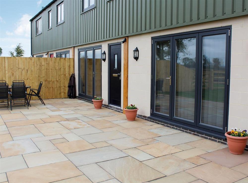 Spacious patio area with garden furniture at Woodland View, 