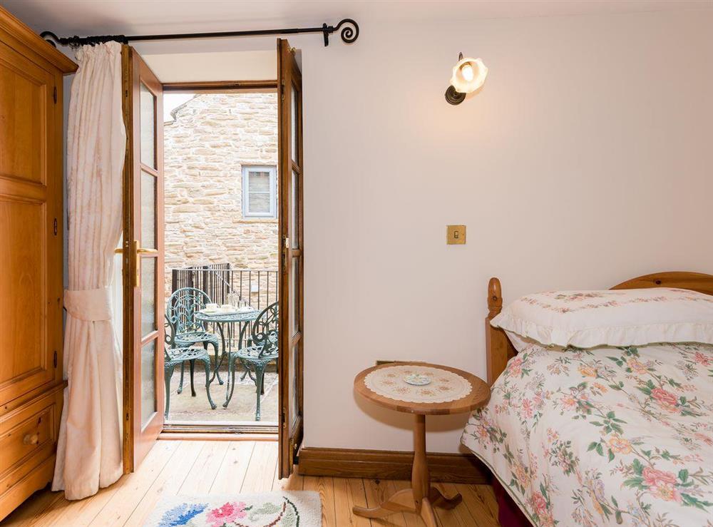Double bedroom with balcony at Wild Goose Cottage in Alston, Cumbria