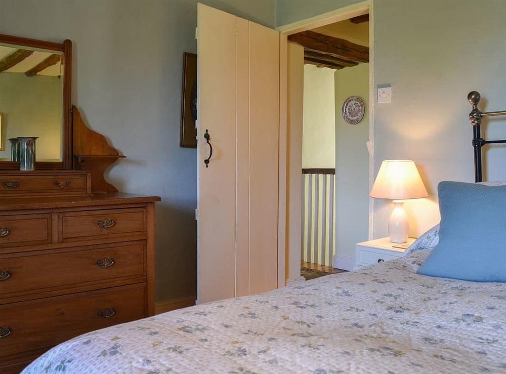 Delightful double bedroom with polished wooden floor at Wilfin Beck Cottage in Cunsey, Windermere., Cumbria
