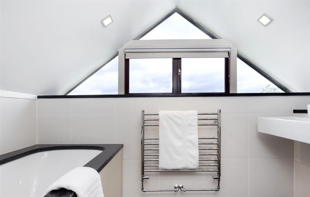 Family bathroom with feature window at Willersey Farm House, Willersey