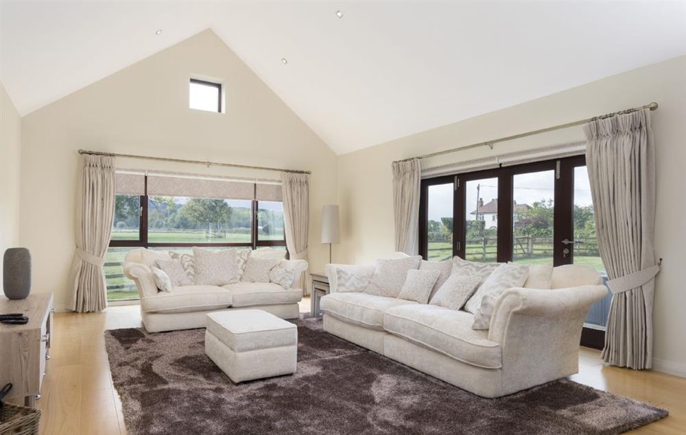 Panoramic views across the countryside from this spacious sitting room at Willersey Farm House, Willersey