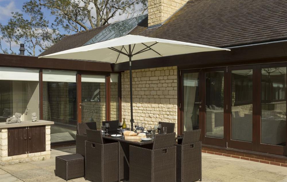 Private patio area with rattan garden furniture at Willersey Farm House, Willersey