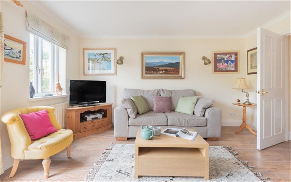 Sitting room with sofa, armchairs and smart TV at Willow Cottage in Dittisham