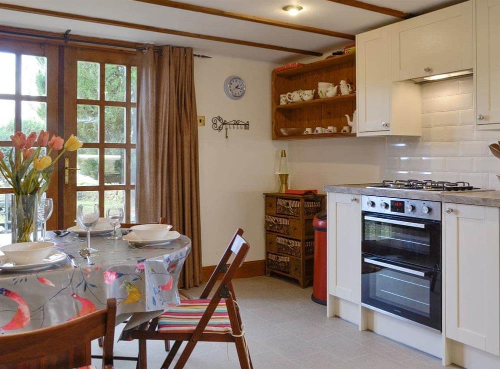 Well-equipped kitchen with dining area at Willow Cottage in Kirriemuir, Angus