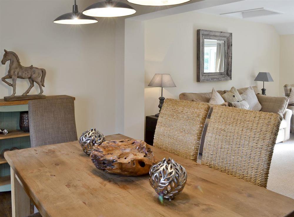 Contemporary dining area with stylish lowered lighting at Willow Tree Cottage in Foxholes, near Driffield, North Yorkshire