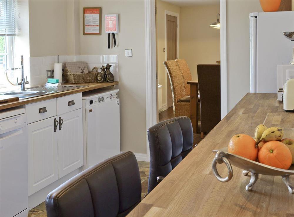 Kitchen is conveniently placed near to the dining area at Willow Tree Cottage in Foxholes, near Driffield, North Yorkshire