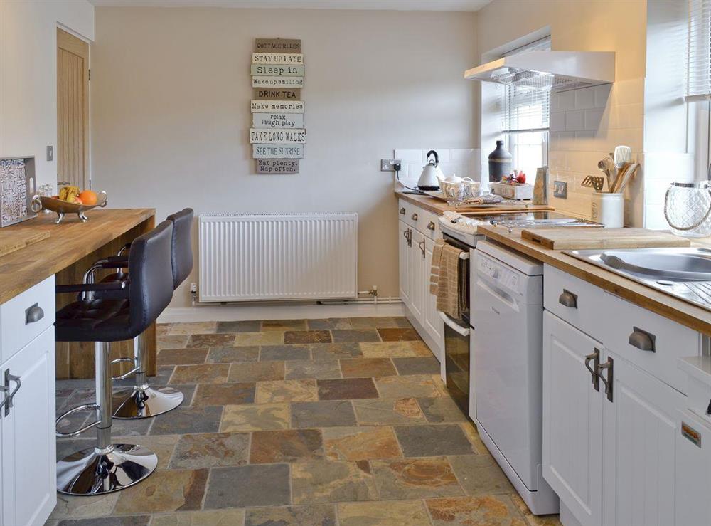 Well-appointed kitchen with breakfast bar and stools at Willow Tree Cottage in Foxholes, near Driffield, North Yorkshire