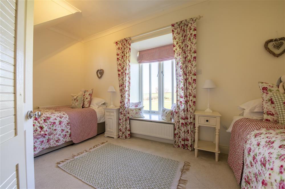 Bedroom four boasts a full height window, that allows the light to flood in at Willowgarth House, Northallerton, North Yorkshire