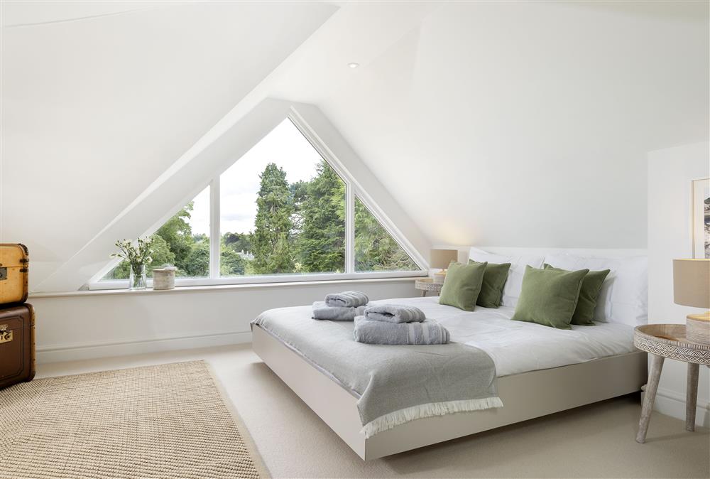 First floor: The stunning master bedroom with feature window at Winacres Cottage, Box, near Stroud