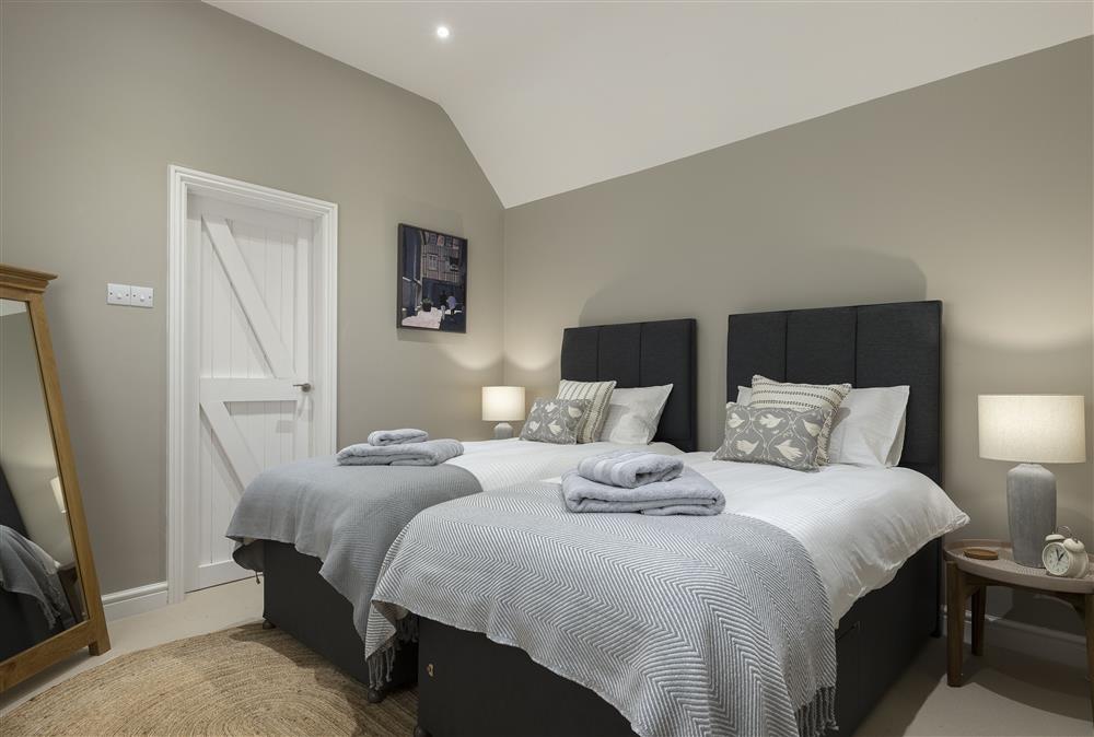 Ground floor: Bedroom with en-suite bathroom and twin zip and link beds, which can be converted to a 6ft super-king size bed on request