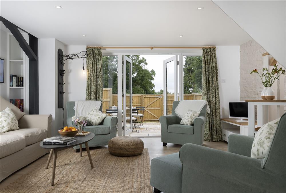 Ground floor: Cosy sitting room with french doors leading out to the pretty patio