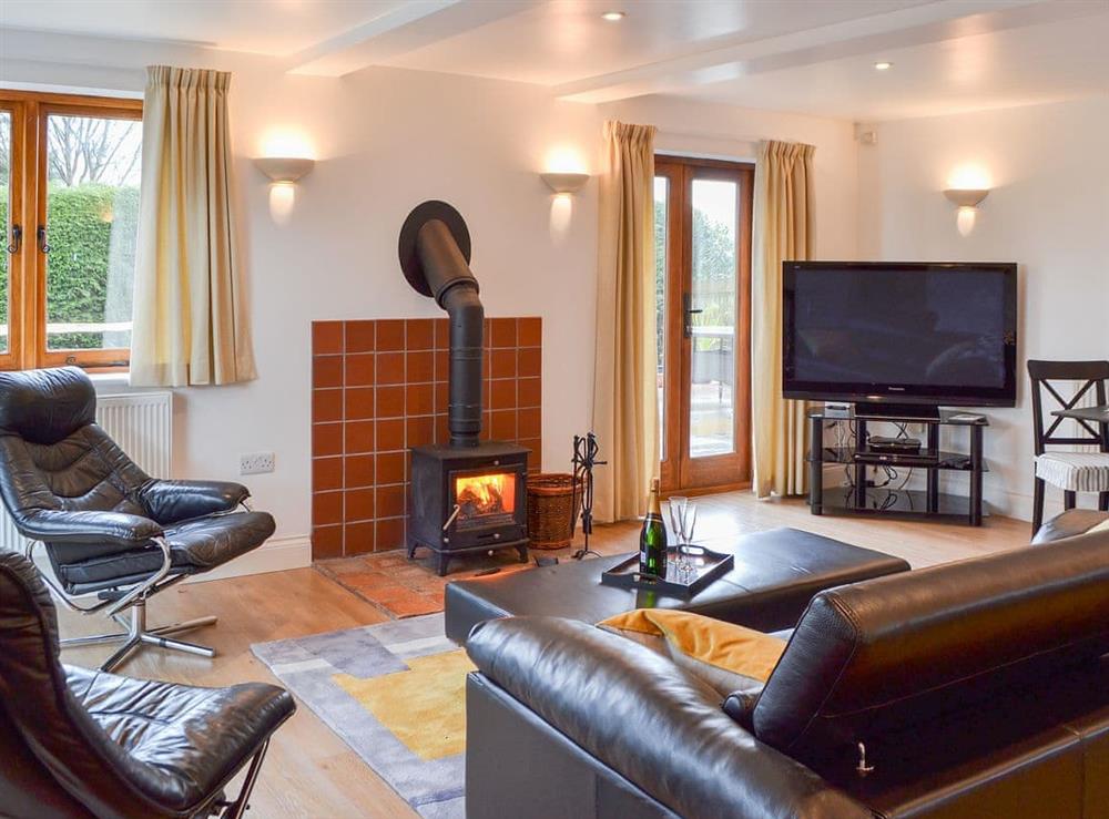 Delightfully spacious living area with French doors to the garden at Windmill Barn in Windmill Hill, near Hailsham, East Sussex