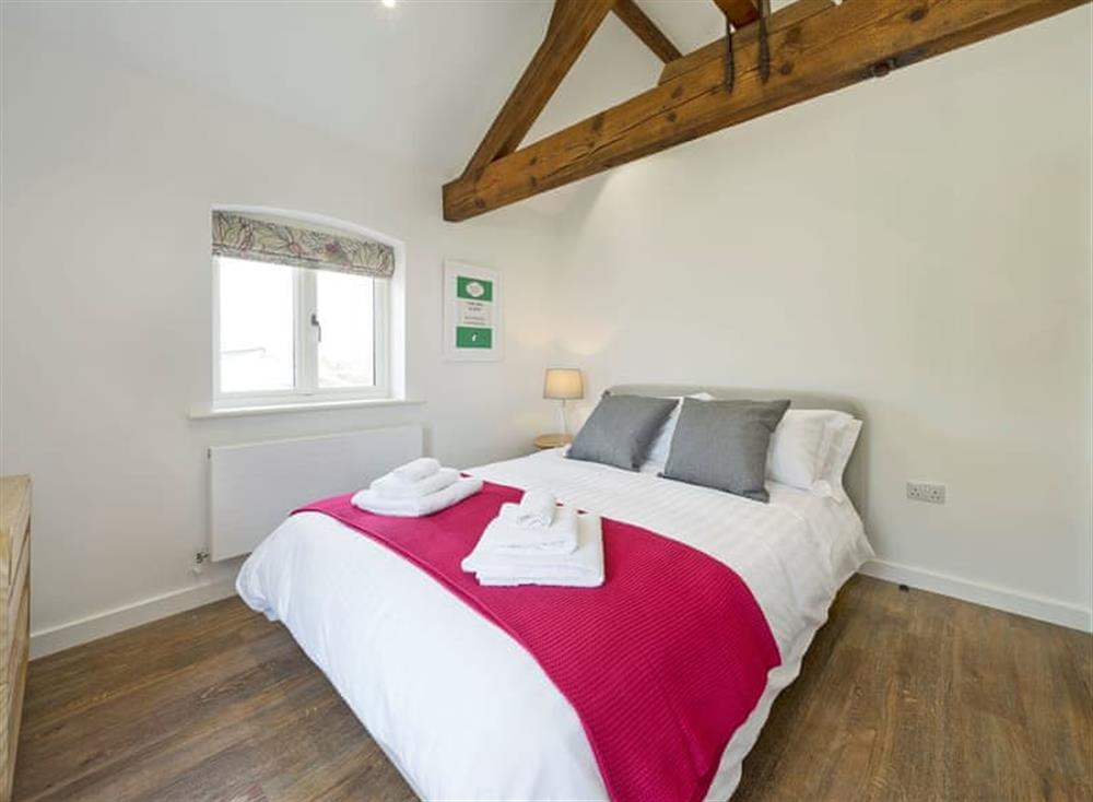 Sumptuous double bedroom with beams at The Cart Barn, 