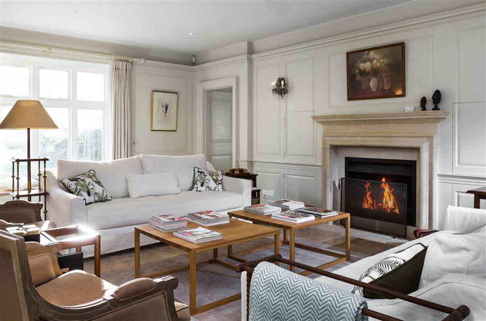 Relax by the wood burning stove in the expansive sitting room