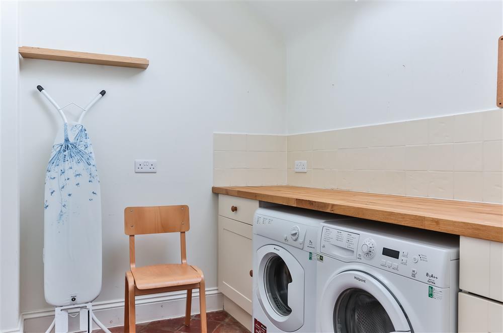 Utility room with a washing machine and tumble dryer