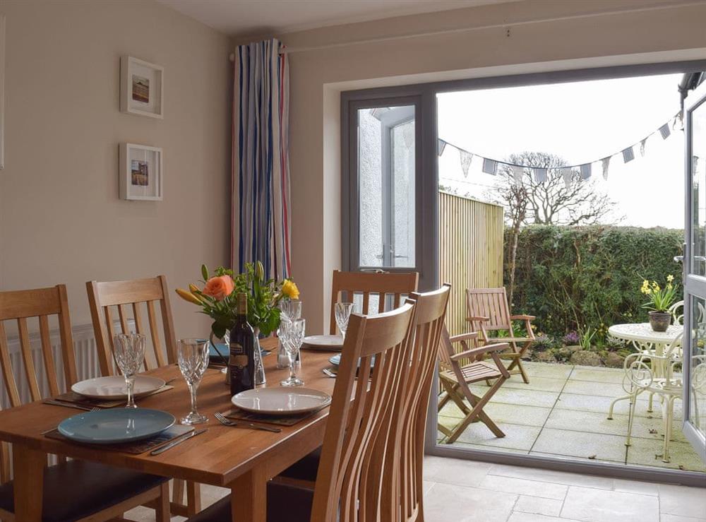 Dining area leading out to patio at Windsmoor Cottage on Gower in Perriswood, near Oxwich, Glamorgan, West Glamorgan