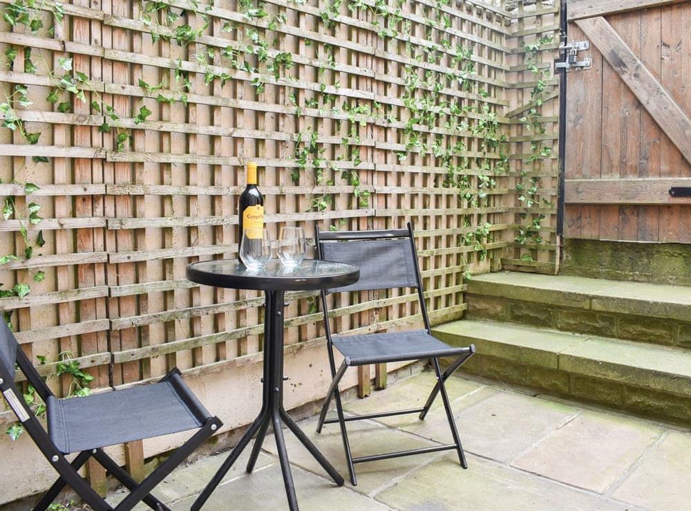 Compact courtyard garden with table and chairs (photo 2) at Windy Dales Cottage in Skipton, Yorkshire, North Yorkshire