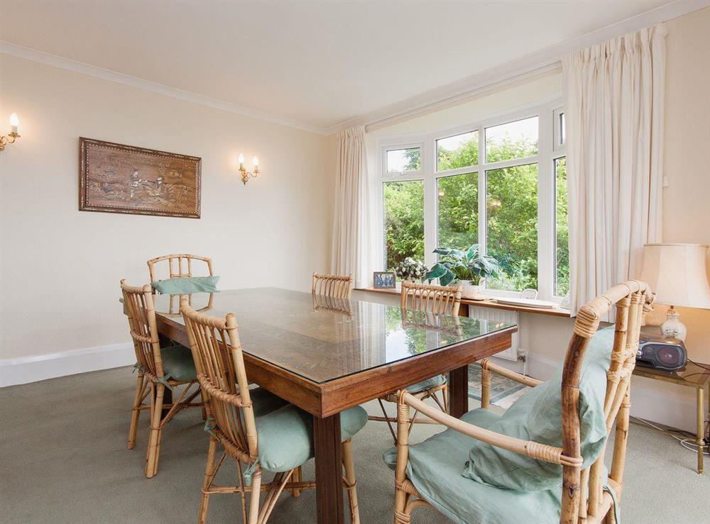 Dining room with sliding glass doors to terrace at Windy Heath in Salcombe, Devon