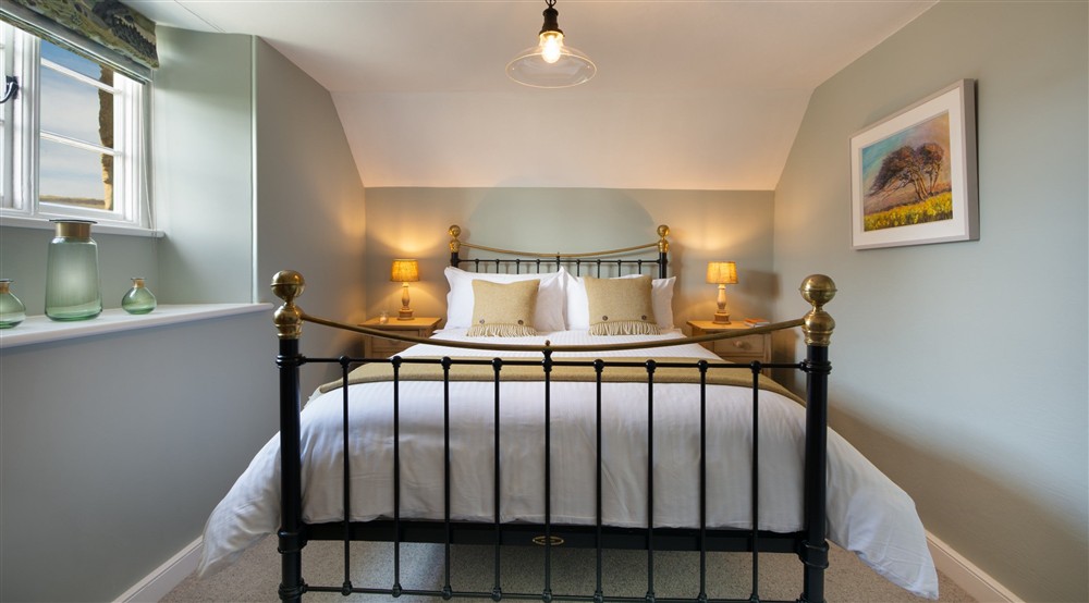 The king-size bedroom at Winnianton Farmhouse in Helston, Cornwall