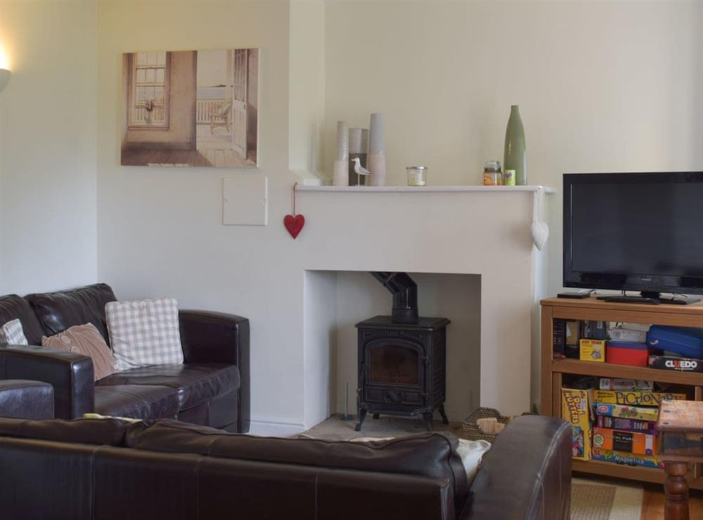 Living room with wood burner at Winsford in Somerford Keynes, near Cirencester, Gloucestershire