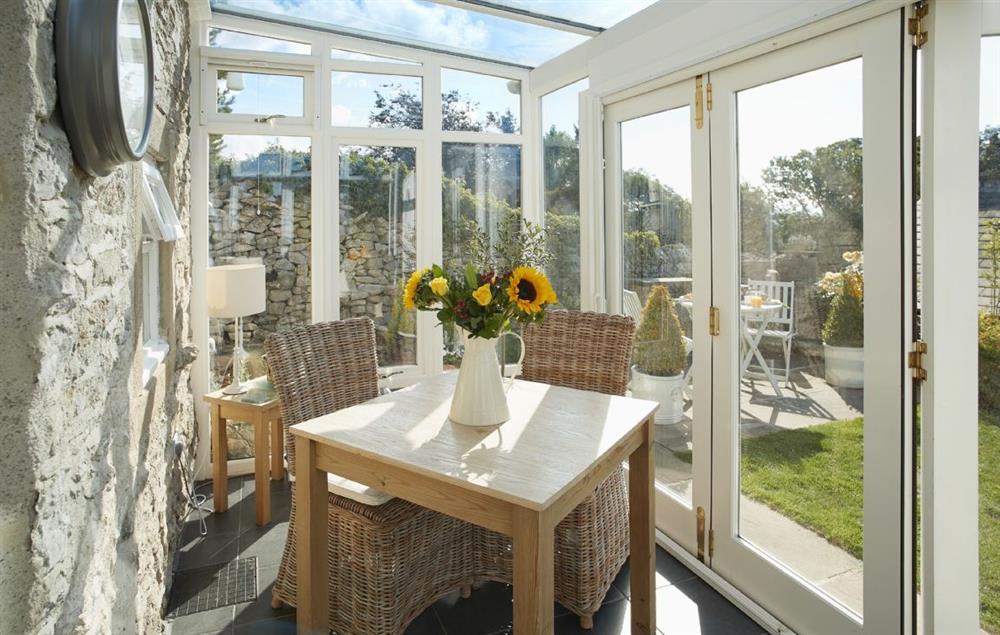 Seating for two in the modern conservatory at Winsmore Cottage, Over Haddon