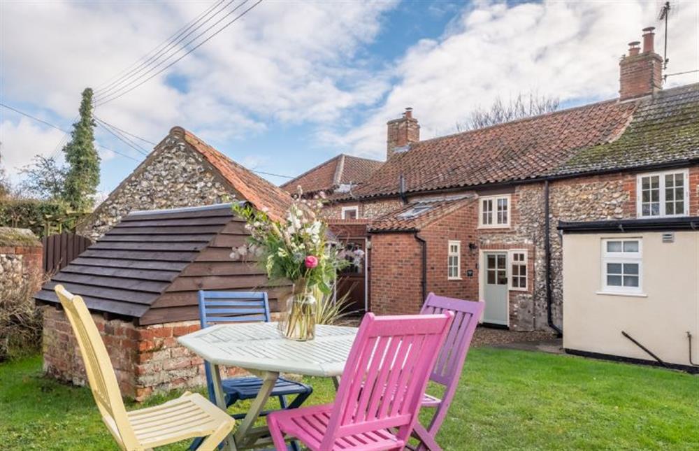 Outdoor seating in the peaceful courtyard at Wishing Well Cottage, North Creake near Fakenham