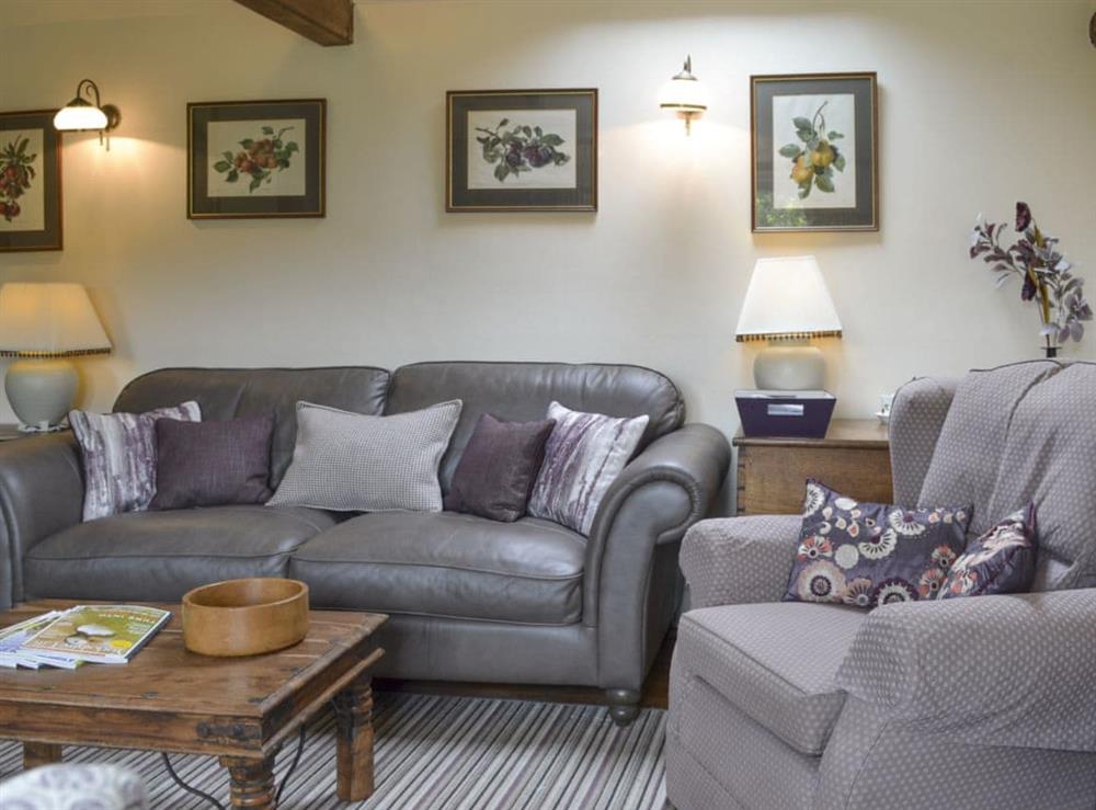 Comfy seating in lounge area at Wisteria Cottage, 