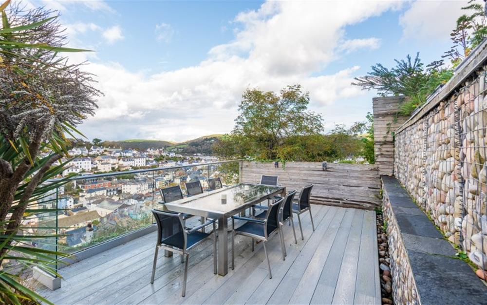 Lower terrace with table and seating for 8 and views across town to the river. at Wisteria House in Dartmouth