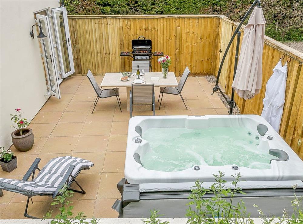 Large enclosed terrace with sitting-out area, garden furniture and gas BBQ at Wits End Cottage in Roughton, near Woodhall Spa, Lincolnshire