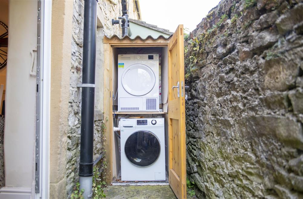 The outside utility area with washing machine and tumble dryer