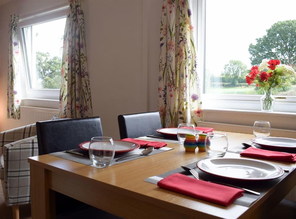 Dining area with views over the garden and beyond at Wokkon Lodge in Castle Pulverbatch, near Shrewsbury, Shropshire