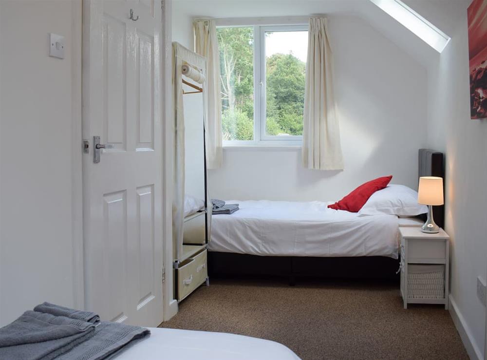 Welcoming bedroom with twin single beds at Wokkon Lodge in Castle Pulverbatch, near Shrewsbury, Shropshire