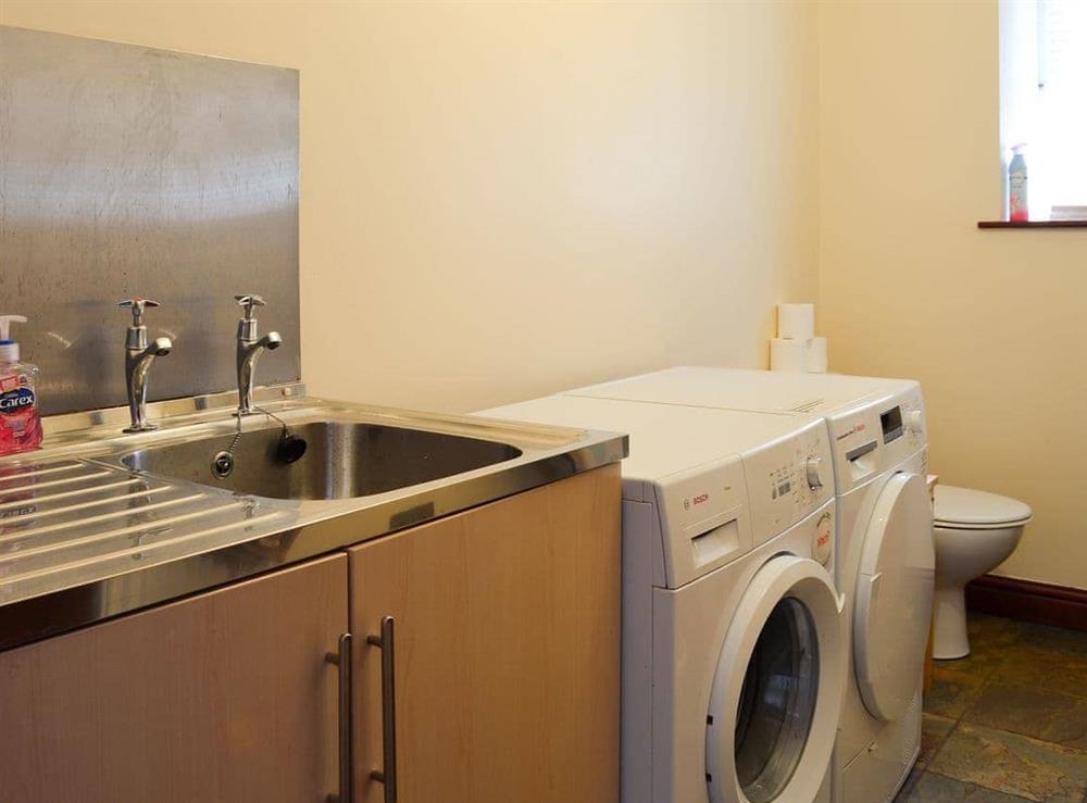 Practical utility room with laundry facilities at Wood Cottage in Buxworth, High Peak, Derbyshire