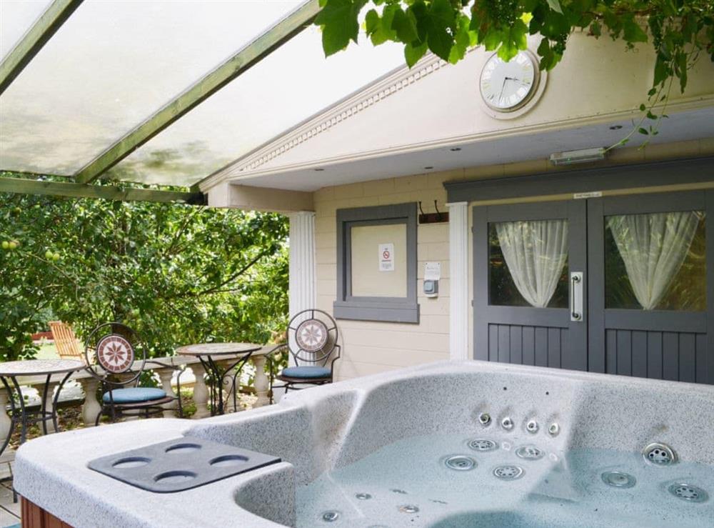 Relax in the private hot tub at Sedge Lodge, 