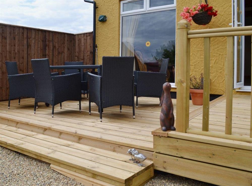 The raised decking are makes a great place for entertaining at Sedge Lodge, 
